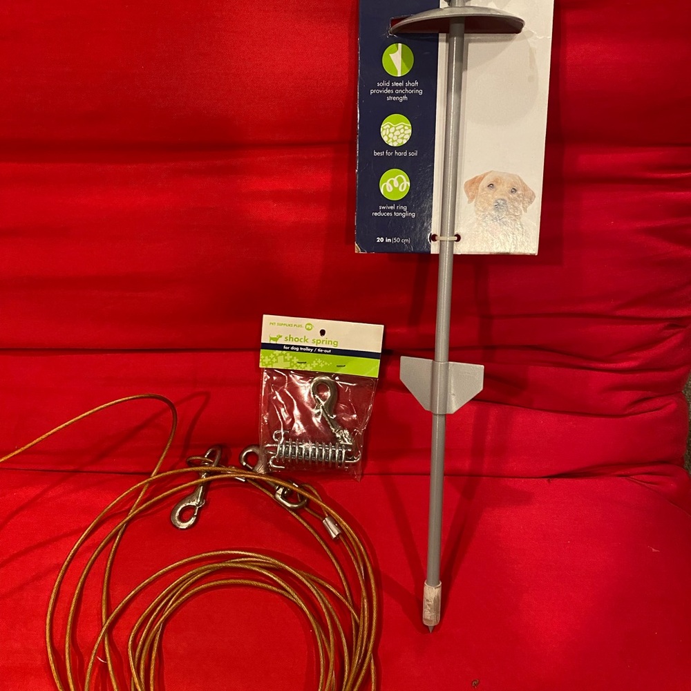 Set up for dog. Includes stake, spring and cord.